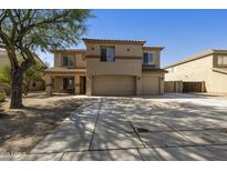 Two-story home boasts a three-car garage, desert landscaping, and neutral stucco exterior at 3423 E Superior Rd, San Tan Valley, AZ 85143