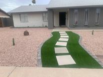 Charming home with a green lawn walkway and desert landscaping features at 4026 W Saint John Rd, Glendale, AZ 85308