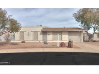 Charming single-story home with a well-maintained yard and inviting curb appeal, garage, neutral colors and rock details at 406 E Saguaro St, Casa Grande, AZ 85122