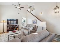 Inviting living room featuring a neutral color palette, plush seating, and a staircase leading to the upper level at 6230 S Mesa Vista Dr, Gold Canyon, AZ 85118