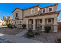 Charming two-story home featuring a cozy front porch and desert landscaping at 663 E Los Arboles Pl, Chandler, AZ 85225