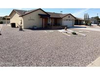 Tan home with a 2-car garage and low maintenance landscaping at 8261 E Fay Ave, Mesa, AZ 85208