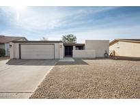 Charming single-story home featuring a xeriscaped front yard and two-car garage at 9021 E Palmer Dr, Sun Lakes, AZ 85248