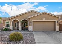 Charming single-story home featuring a well-manicured desert landscape and a two-car garage at 10339 E Juanita Ave, Mesa, AZ 85209