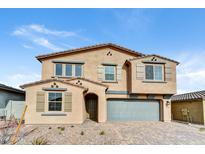 Two-story home with a neutral color scheme, paired with a well-manicured front yard and a gray two-car garage at 13386 W Eagle Feather Rd, Peoria, AZ 85383