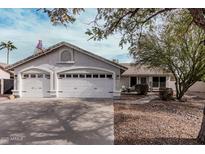 Charming one-story home featuring a two car garage, desert landscaping, and neutral colored stucco at 1431 S Nielson St, Gilbert, AZ 85296