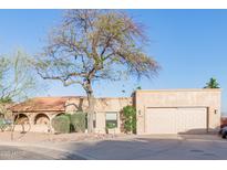 Charming single-story home featuring a two-car garage and desert landscaping at 15843 E Mustang Dr, Fountain Hills, AZ 85268