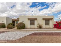 Charming single-story home with decorative rock landscaping and mature shrubbery at 17247 N 106Th Ave, Sun City, AZ 85373