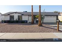 Charming single-story home featuring a well-maintained front yard and attached two-car garage at 18 N 132Nd St, Chandler, AZ 85225