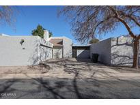 Contemporary-style home with a private courtyard and stucco walls showcasing clean architectural lines at 2113 N Squire Ave, Tempe, AZ 85288