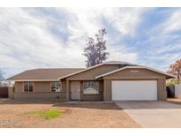 Charming single-story home with well-maintained lawn, two car garage, and inviting curb appeal at 2643 E Jerome Ave, Mesa, AZ 85204