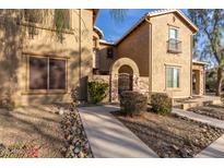 Charming exterior view of a home with a stone-accented entrance and well-maintained landscaping at 28735 N 21St Ave, Phoenix, AZ 85085