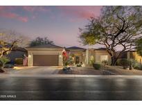 Charming single-story home with desert landscaping and a two-car garage at 33389 N 71St St, Scottsdale, AZ 85262