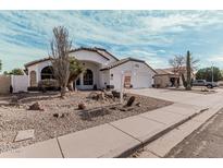 Charming single-story home features desert landscaping and a pristine white exterior in a quiet neighborhood at 441 S Dodge Dr, Chandler, AZ 85225