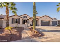 Charming single-Gathering home featuring desert landscaping, a three-car garage, and tile roof at 4756 W Nogales Way, Eloy, AZ 85131