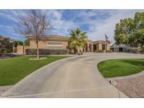 Expansive driveway leading up to the inviting desert home with well manicured landscaping at 4915 N Greentree Dr, Litchfield Park, AZ 85340