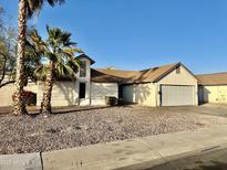 Well-maintained single-story home featuring a two-car garage and drought-resistant landscaping at 5552 W Willow Ave, Glendale, AZ 85304