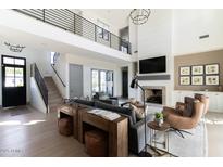 Stunning living room with high ceilings, fireplace, and balcony access for a modern feel at 5601 E Monterosa St, Phoenix, AZ 85018