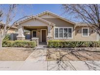Charming single-story home with a cozy front porch, manicured landscaping, and stone accents at 1170 S Agnes Ln, Gilbert, AZ 85296