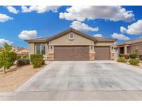 Attractive single-story home with a three-car garage and well-maintained desert landscaping at 12180 W Rio Vista Ln, Avondale, AZ 85323
