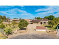 Charming home exterior with large yard, mature trees and automatic gate at 14801 N 78Th Ln, Peoria, AZ 85381