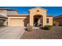 Charming single-story home featuring a front yard with desert landscaping and a two-car garage at 16038 W Acapulco Ln, Surprise, AZ 85379