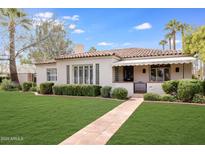 Charming single-story home featuring a tile roof, a lush front yard, and a welcoming walkway at 1631 Palmcroft Se Dr, Phoenix, AZ 85007