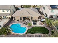 Aerial view of backyard with a pool, turf, spa, and desert landscaping, providing a private and luxurious outdoor space at 18143 W Buckhorn Dr, Goodyear, AZ 85338