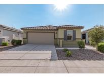 Charming single-story home featuring a two-car garage and low maintenance desert landscaping at 18224 N Toledo Ave, Maricopa, AZ 85138