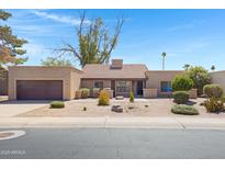 Charming single-story home with desert landscaping, tile roof, and attached two-car garage at 1827 E Manhatton Dr, Tempe, AZ 85282