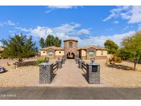 Charming single-story home with meticulously landscaped front yard and a welcoming pathway at 18346 W Rancho Ct, Litchfield Park, AZ 85340