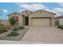 Charming single-story home featuring a brick driveway, two car garage and low maintenance desert landscaping at 4609 S 122Nd S Dr, Avondale, AZ 85323