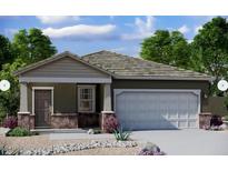 Charming single-story home with stone accents, desert landscaping, and a two-car garage at 6130 E Artemis Dr, Florence, AZ 85132