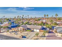 Charming single-story brick home with a well-manicured desert landscape and a two-car garage at 7616 W Wagoner Rd, Glendale, AZ 85308