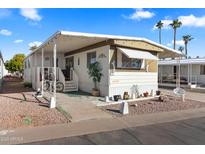 Charming home featuring a covered porch, landscaped yard, and delightful curb appeal at 7807 E Main St # Aa-8, Mesa, AZ 85207