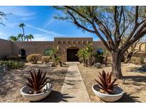 Charming desert home featuring xeriscaping, native plants, and a stone pathway to the front entrance at 10834 N 45Th St, Phoenix, AZ 85028