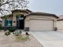 Charming home featuring desert landscaping and an attached two-car garage at 1203 W Mesquite Tree Ln, San Tan Valley, AZ 85143