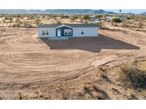 Charming single-story home featuring a modern blue door and gray exterior paint at 164 S Oak Rd, Maricopa, AZ 85139