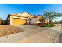 Charming single-story home with well-maintained landscaping and a two-car garage at 1743 N 213Th Dr, Buckeye, AZ 85396