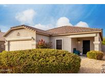 Charming home with desert landscaping, tile roof, and covered front porch at 1942 E Connemara Dr, San Tan Valley, AZ 85140