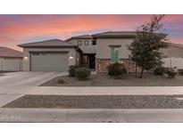 Charming home featuring well-maintained landscaping, a two-car garage, and a welcoming facade at 21765 E Arroyo Verde Dr, Queen Creek, AZ 85142