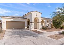 Inviting single-story home featuring arched porch, two-car garage, and low-maintenance desert landscaping at 22538 E Tierra Grande --, Queen Creek, AZ 85142