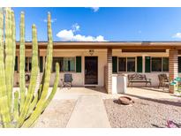 Inviting front porch featuring desert landscaping, seating and secure front door entry at 2442 E University Dr # 6, Mesa, AZ 85213