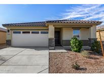 Charming single-story home featuring a two-car garage, desert landscaping and a tile roof at 24531 W Cocopah St, Buckeye, AZ 85326