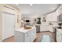 Bright kitchen features a center island, white cabinets, and an open concept design at 2511 W Queen Creek Rd # 163, Chandler, AZ 85248