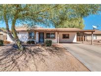 Charming single-story home featuring desert landscaping and a covered carport at 2744 E John Cabot Rd, Phoenix, AZ 85032