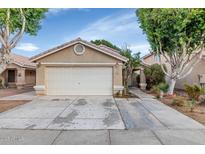Charming single-story home with a spacious two-car garage and desert landscaping at 5002 W Wikieup Ln, Glendale, AZ 85308