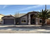 Charming single-story home featuring a tile roof, arched entryway and low maintenance desert landscaping at 5031 S Roosevelt St, Tempe, AZ 85282