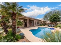 Stunning backyard featuring a sparkling pool surrounded by lush landscaping, creating a private outdoor oasis at 5670 W Irma Ln, Glendale, AZ 85308