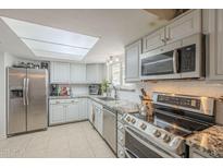 Well-lit kitchen featuring stainless steel appliances and granite countertops at 6251 E Hannibal St, Mesa, AZ 85205